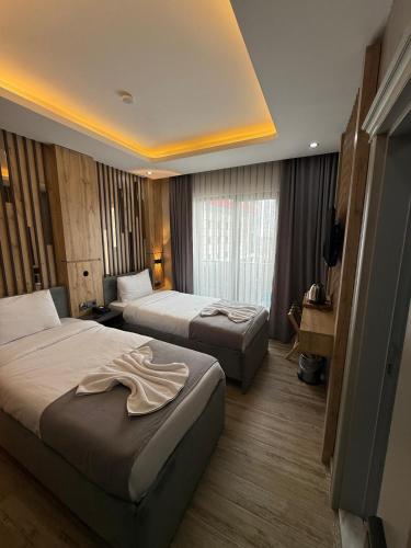 a hotel room with two beds and a television at world say hotel in Bostaniçi