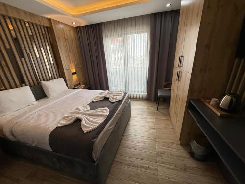 a bedroom with a large bed in a room at world say hotel in Bostaniçi
