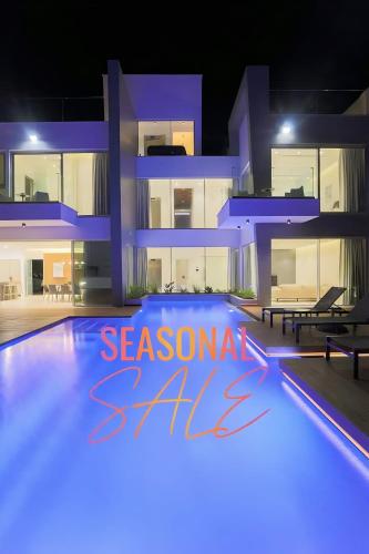 a villa with a swimming pool at night at Seaview Luxury Villas Ayia Napa in Ayia Napa