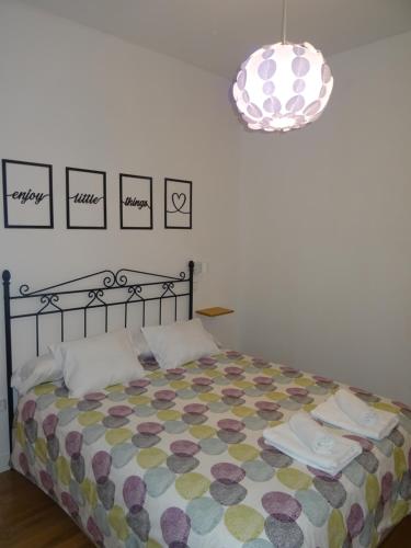 a bedroom with a bed and a pendant light at VUT Casa de la Catedral Baja in Sigüenza