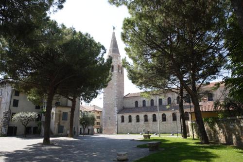 an old building with a tower and a church at Costa Azzurra Apartment in Grado