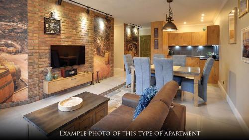a living room with a table and a dining room at Norweska Dolina Family&Pet-friendly Resort in Szklarska Poręba