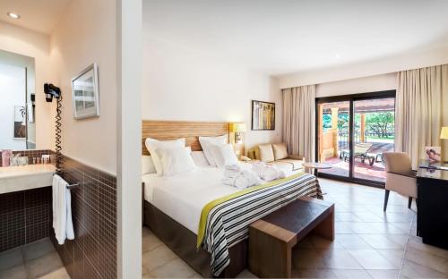 a hotel room with a bed and a balcony at Barceló Punta Umbría Beach Resort in Punta Umbría