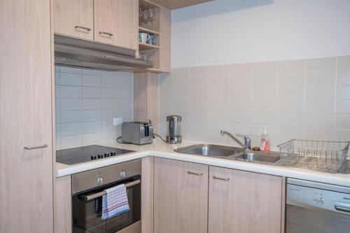 a small kitchen with a sink and a stove at Contemporary 2BR apartment near Kingston - Hosted by Canstay in Kingston 