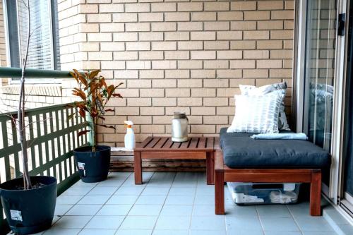 a patio with a bench and a table on a porch at Contemporary 2BR apartment near Kingston - Hosted by Canstay in Kingston 