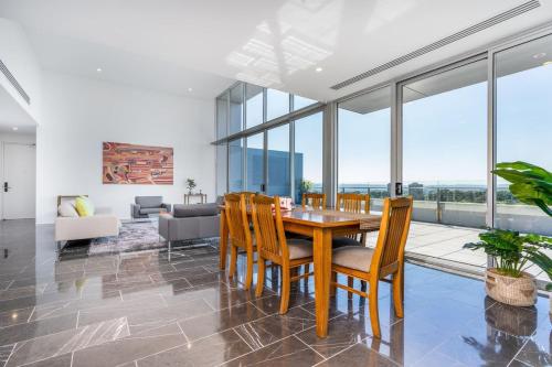 a dining room with a table and chairs at Modern 3BR Home 5 mins away from Parliament House - Hosted by Canstay in Barton