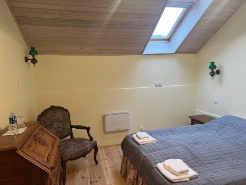 a bedroom with a bed and a chair and a window at Ledainė in Naujasodis