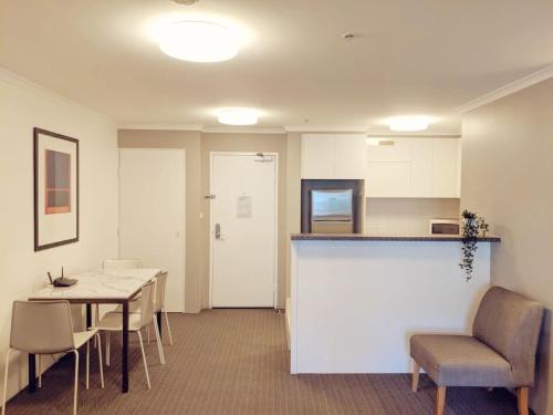 a kitchen and dining room with a table and chairs at Exquisite Apartment at Citys Doorstep - Hosted by Canstay in Canberra