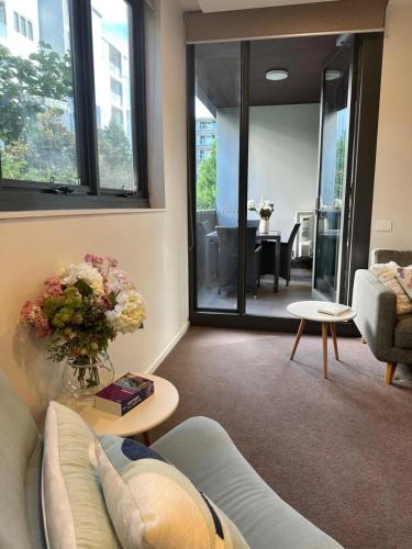 a living room with a couch and a table at Cosy getaway in the Heart of Braddon - Hosted by Canstay in Canberra
