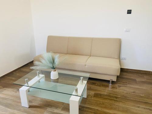a living room with a couch and a glass coffee table at Relais Green Paradise in Apice