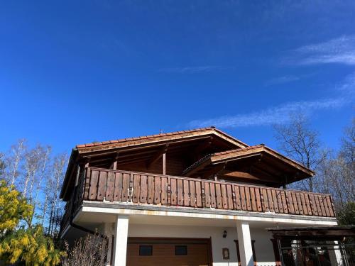 a house with a balcony on top of it at QuickHome Villa Anita in Sala Biellese