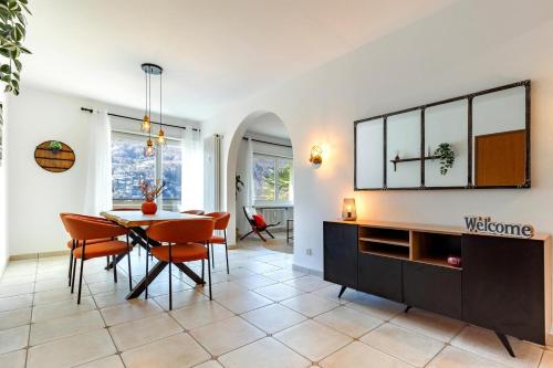 a dining room with a table and chairs at Elegant, Lugano Lake View, pool and private parking in Brusino Arsizio