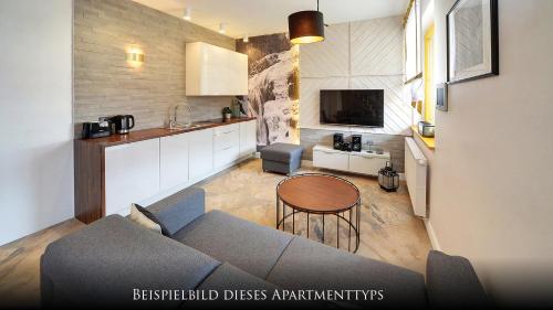 a living room with a couch and a table at Norweska Dolina Family&Pet-friendly Resort in Szklarska Poręba
