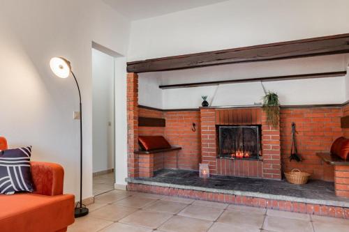 a living room with a brick fireplace at Elegant, Lugano Lake View, pool and private parking in Brusino Arsizio