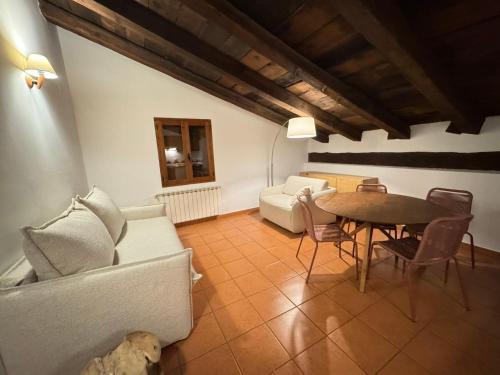 a living room with a couch and a table at El Molí Nou - Rural flats in Peñarroya de Tastavins