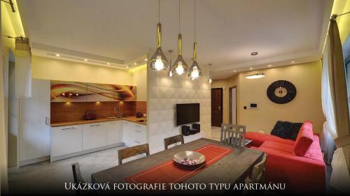 a living room with a table and a red couch at Norweska Dolina Family&Pet-friendly Resort in Szklarska Poręba