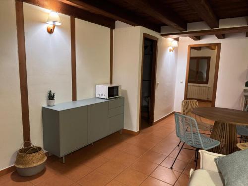 a living room with a counter with a microwave on it at El Molí Nou - Rural flats in Peñarroya de Tastavins