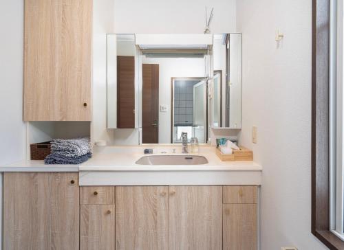 a bathroom with a sink and a mirror at Perfect Winter Villa Retreat - 14 minutes to downtown in Sapporo