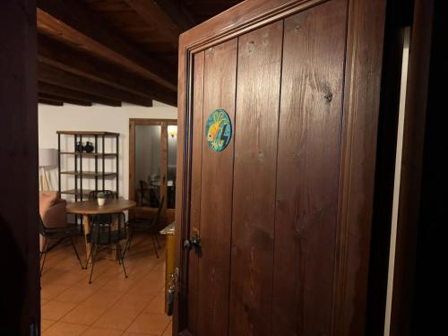 a wooden door with a sticker on it next to a table at El Molí Nou - Rural flats in Peñarroya de Tastavins