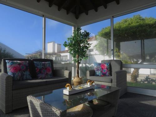 a living room with two couches and a table at Mosteiros Coastal Haven in Mosteiros