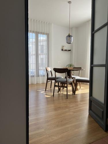 a dining room with a table and chairs at Elysium Luxury Stays in Melegis