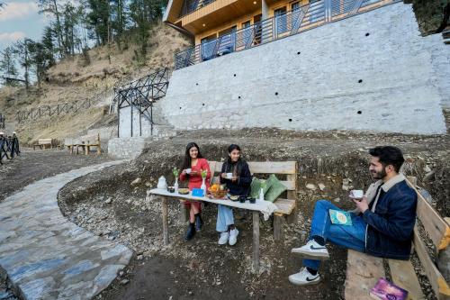 a group of people sitting at a table at SaffronStays Bagh Kufri in Kūfrī