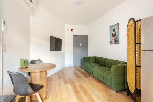 a living room with a green couch and a table at Cozy Stay Near Fishtown - Close to Subway & Center City by Globenest in Philadelphia