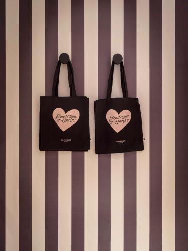 two black bags with hearts on them hanging on a wall at Flemings Hotel Frankfurt-Central in Frankfurt/Main