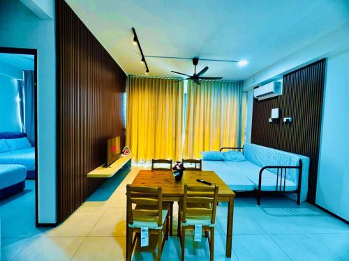 a living room with a table and a couch at Stunning Luxury Breathtaking Sea & City Views 3BR 12PAX in Jelutong