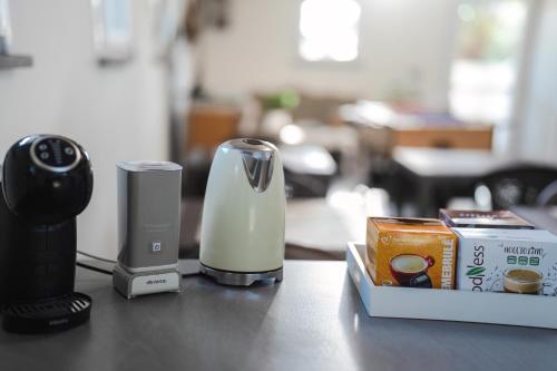 a counter top with a coffee maker and a box of food at Mi casa es tu casa 104 in Portoscuso