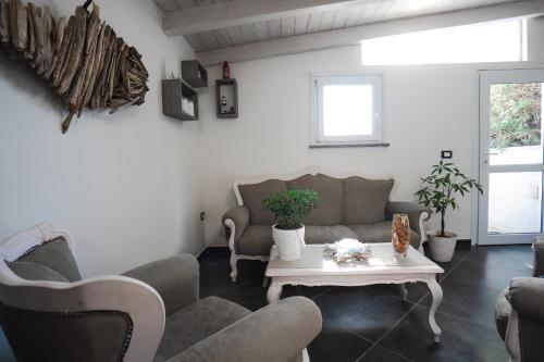 a living room with a couch and a table at Mi casa es tu casa 104 in Portoscuso
