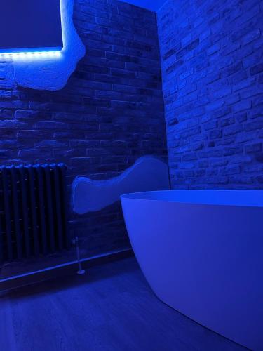 a dark room with a radiator and a white bath tub at INsideOUT RELAX in Porto SantʼElpidio