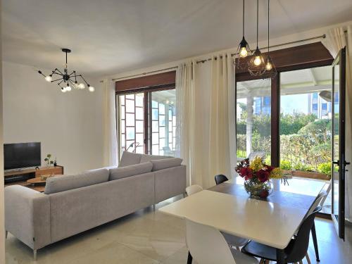 a living room with a couch and a table at Modern Villas at Perla Resort in Durrës