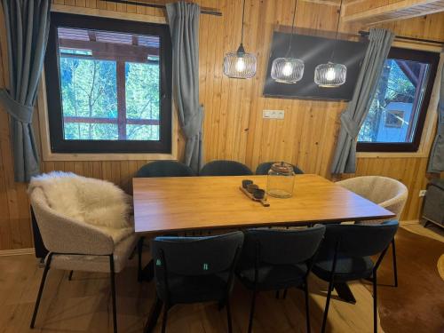 a dining room with a wooden table and chairs at Mountain Mia in Šišava