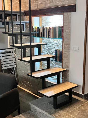 a library with wooden shelves on a brick wall at La Sosta nel Borgo in Anguillara Sabazia