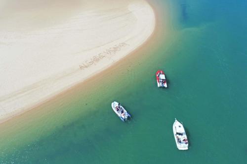 three boats in the water next to a beach at Villa Isa Joe by Algarve Vacation in Almancil