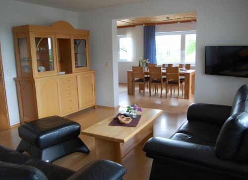 a living room with a couch and a table at Ferienwohnung Matzenmiller in Wilhelmsdorf