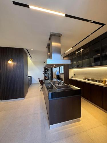 a kitchen with a stove and a counter top at Dabouq Luxurious Penthouse in Amman