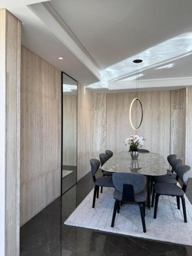 a dining room with a table and chairs at Dabouq Luxurious Penthouse in Amman