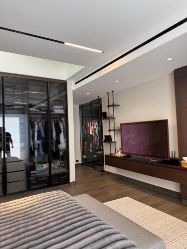 a room with a tv and a bed in it at Dabouq Luxurious Penthouse in Amman
