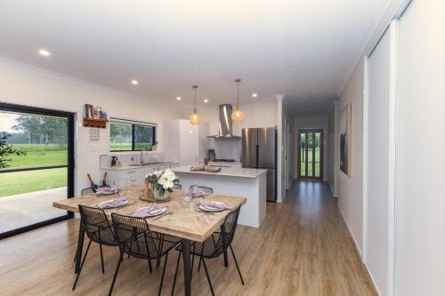 a kitchen and dining room with a table and chairs at The Olive Abode - Atherton in Atherton