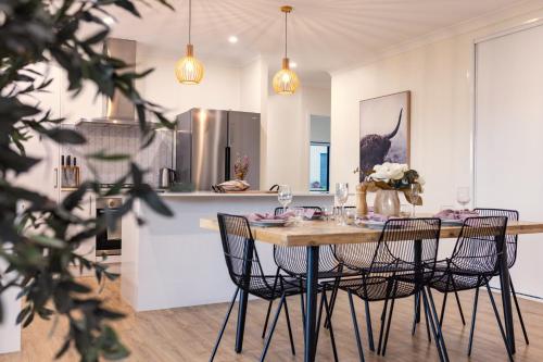 a kitchen and dining room with a table and chairs at The Olive Abode - Atherton in Atherton