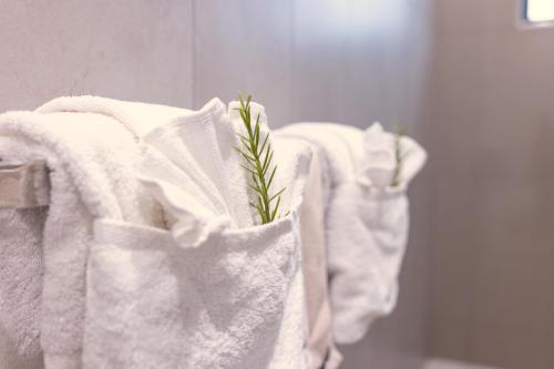 a group of towels on a rack in a bathroom at The Olive Abode - Atherton in Atherton