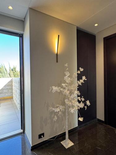 a wall with a painting of a tree on it at Dabouq Luxurious Penthouse in Amman