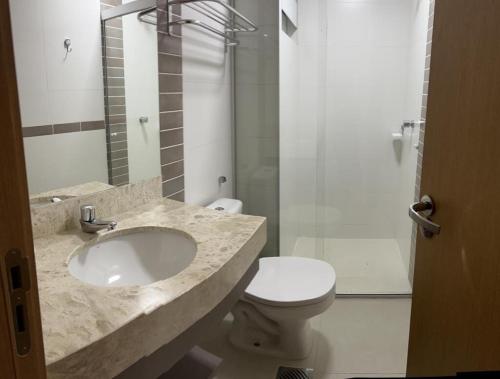 a bathroom with a sink and a toilet and a shower at APTO 115 Park Veredas - Vista Piscinas - Acesso ao Rio quente - Espetacular in Rio Quente