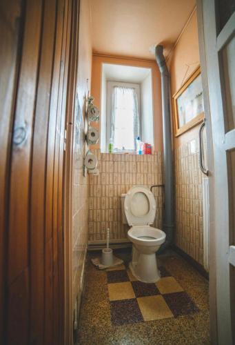 a small bathroom with a toilet and a window at Bambouland in Juranville