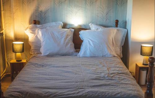 a person laying on top of a bed with pillows at Bambouland in Juranville