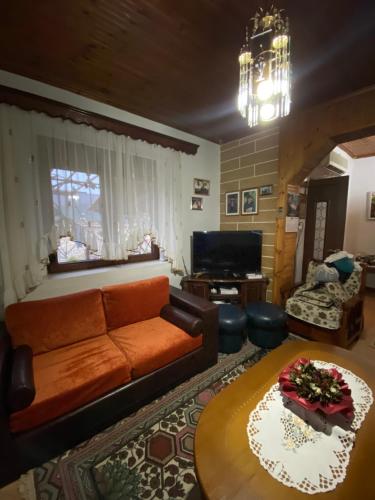a living room with a couch and a table at Guest House Guri in Kakrukë