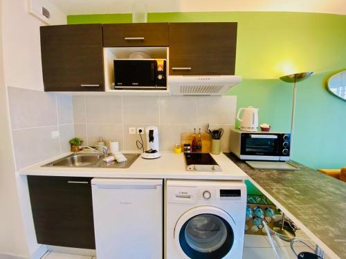 une cuisine avec un évier et une machine à laver dans l'établissement 