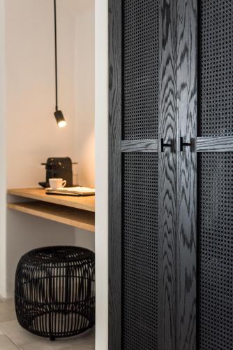 a black door with a stool next to a counter at Porto Fira Suites in Fira
